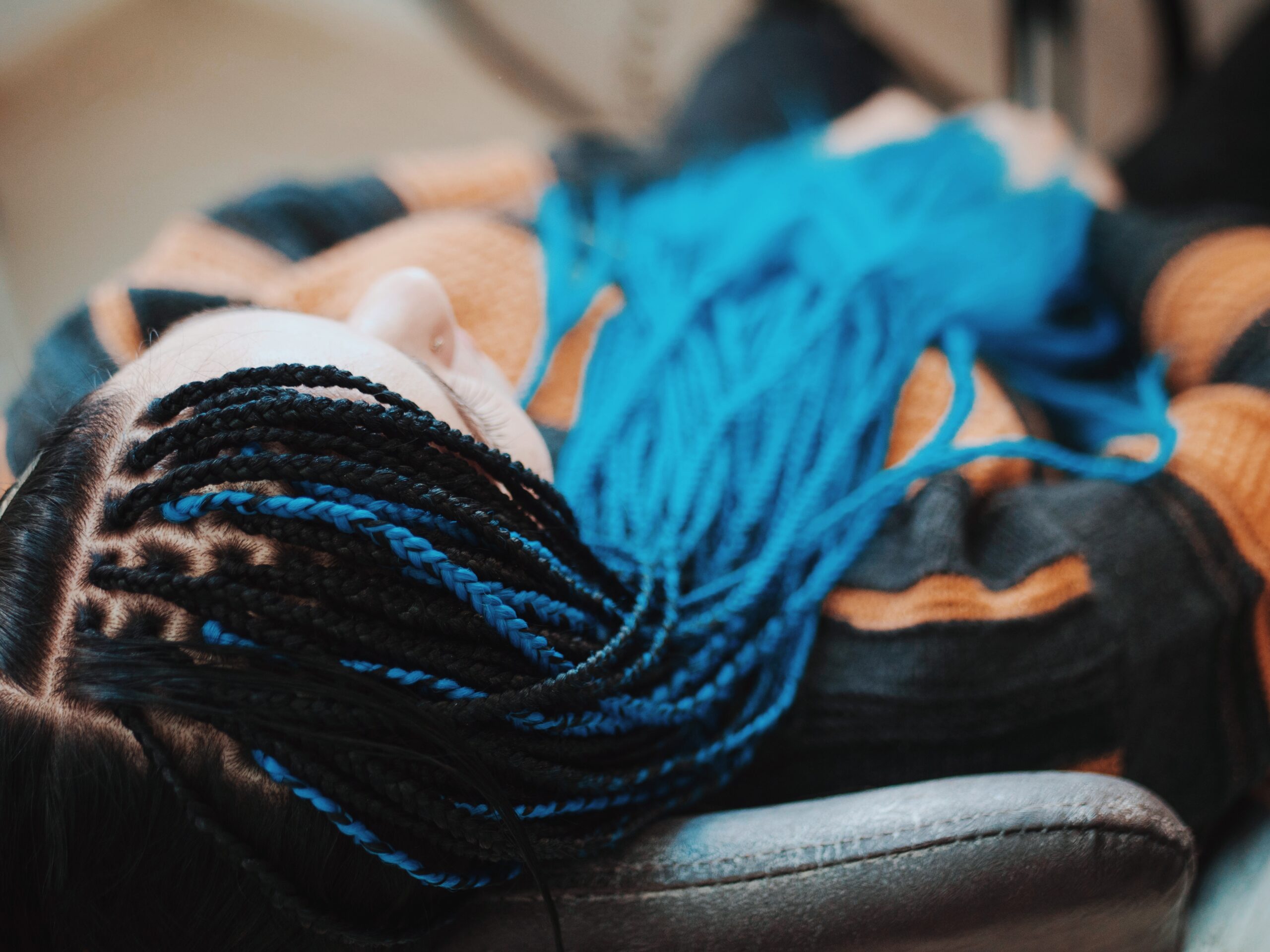Top view on woman's hand with african braids. She sitting in beauty salon.